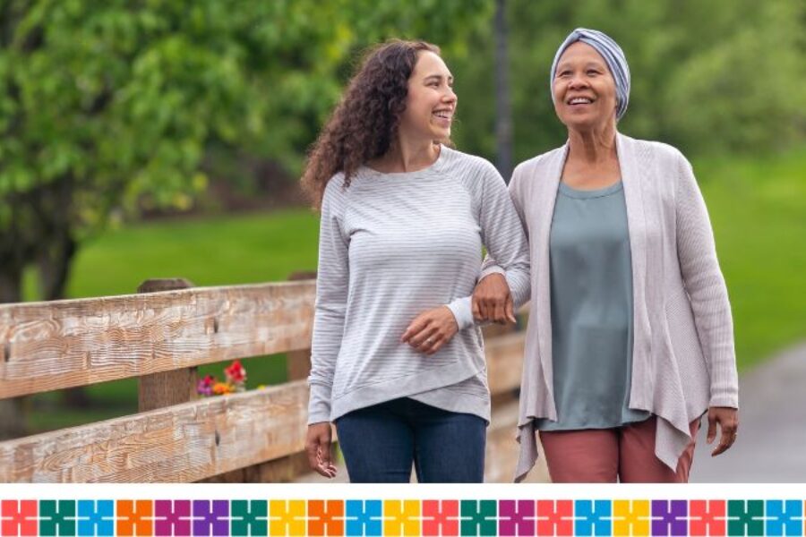 Cancer patient walking with adult daughter