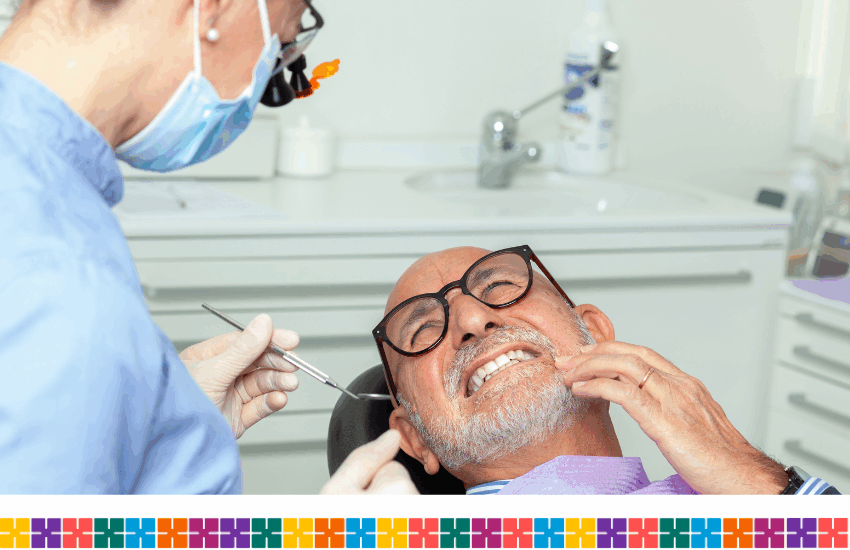 Man with toothache being checked by dentist