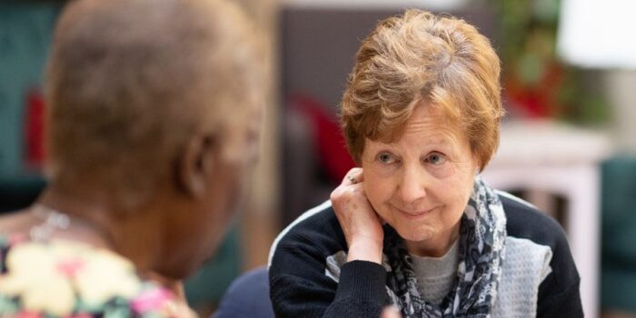 Older lady listening intently to conversation