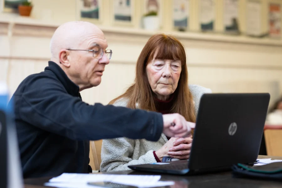 Older man and woman looking at laptop