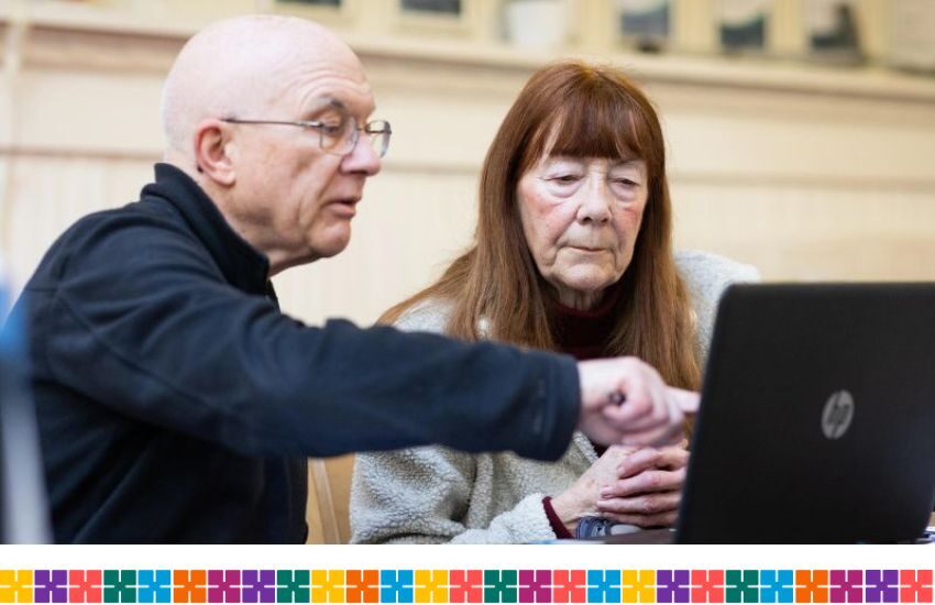 Older man and woman looking at laptop together